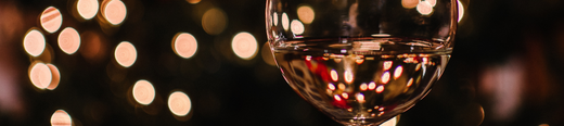 Glass of white wine in cozy light background
