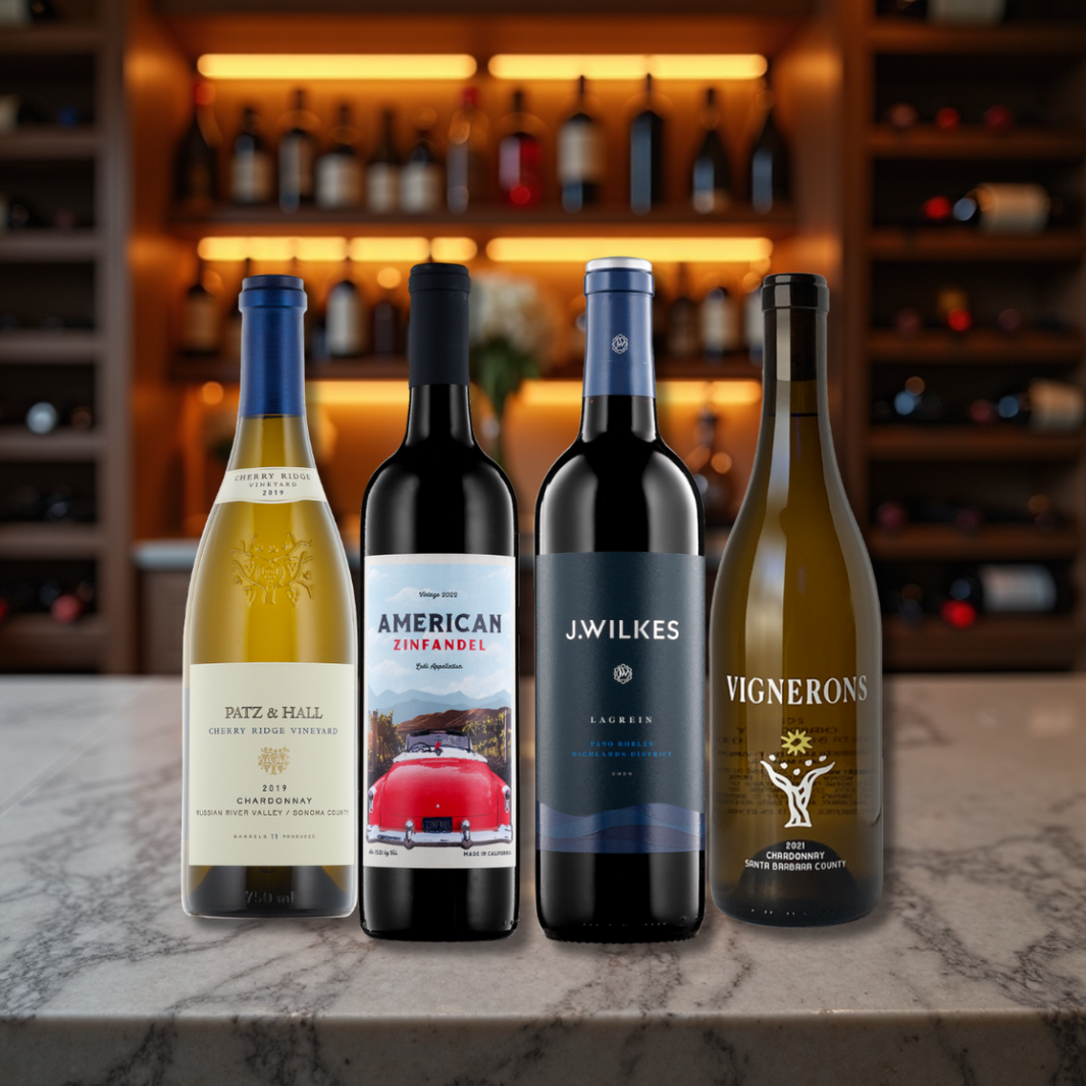 Four wine bottles on a marble surface with a blurred bar background