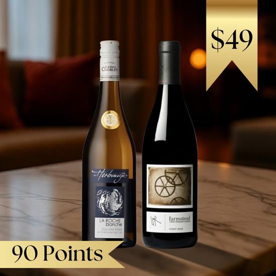 Two wine bottles on a table with a blurred background and price tag.